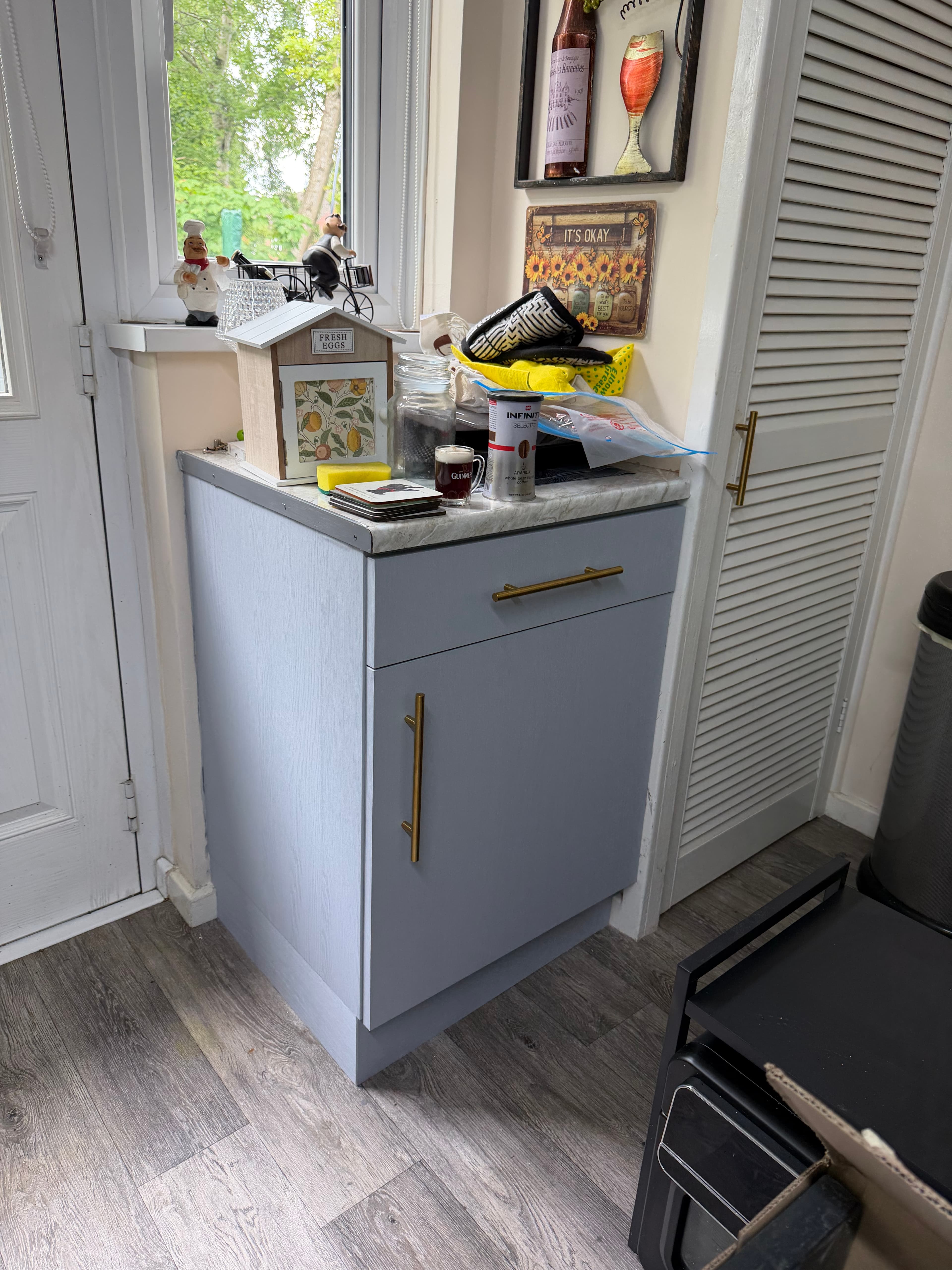 Powder blue kitchen cabinet wrap with marble worktop in Sheffield